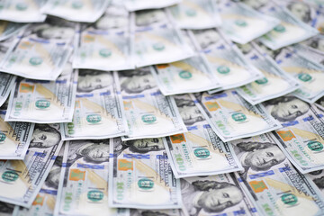 Group of money stack of 100 US dollars banknotes a lot of the background texture. Cash money in a large pile as a finance background.