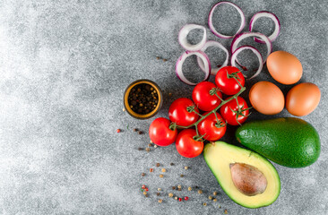 Variety of vegetables on grey concrete table top view. Healthy food background.