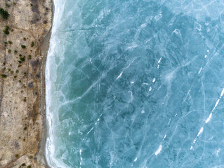 Beautiful blue frozen crystal clean lake aerial drone view at early spring.