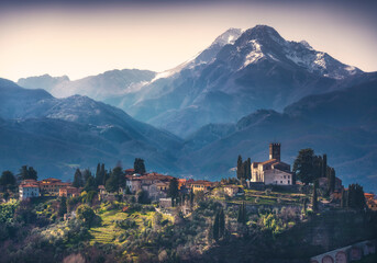 Barga town and Alpi Apuane mountains in winter. Garfagnana, Tuscany, Italy. - obrazy, fototapety, plakaty
