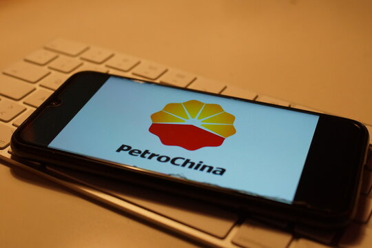 Leipzig, Germany - February 10, 2021: Closeup of smartphone screen with logo lettering of Petrochina on computer keyboard (focus on center upper lettering)