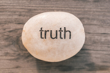 Truth stone with wooden background