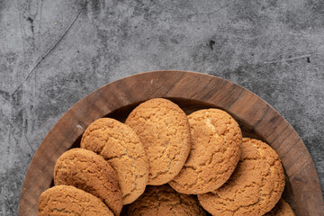 Close up photo of fresh homemade cookies on wooden tray