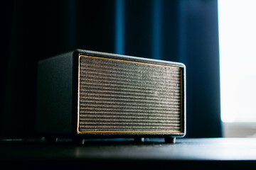 Radio receiver. A modern radio sits on a white table in the kitchen. The music column of the device. Stylish music radio channel receiver.