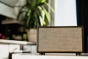 A modern radio sits on a white table in the kitchen. Accepts the melody channel link. Music...
