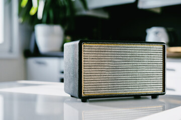 Music is playing. A vintage radio sits on a white table in the kitchen. They broadcast the morning...