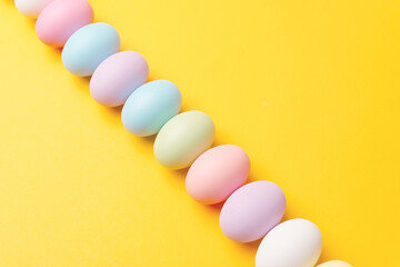 Photo of decorated easter eggs over yellow background.