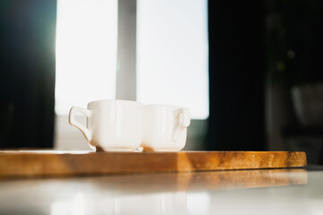 Espresso Americano is on the table. An invigorating delicious drink instead of an energy drink. Ceramic cups of white light coffee. A hot, flavorful drink.