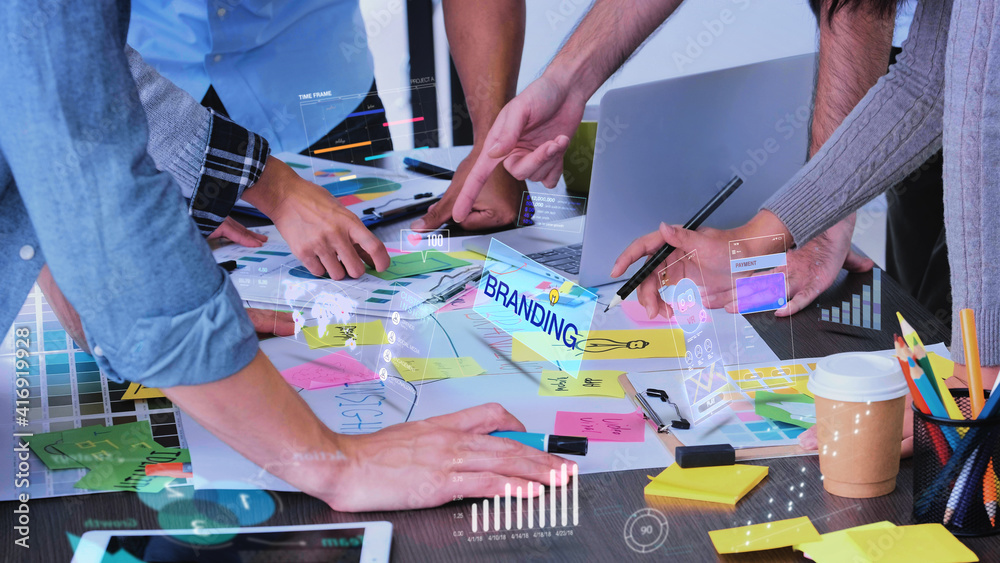 Wall mural close up creative designer use augmented reality app brainstorming about branding on desk at modern 