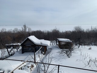 small village country house (cottage) covered with snow in winter 