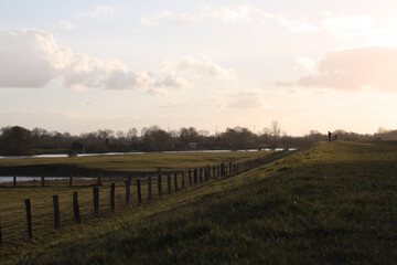 sunset over the field on a dike close to the Weser, Germany