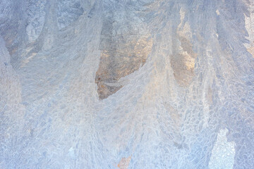 frosty patterns on the window glass closeup. natural textures and backgrounds. ice patterns on frozen