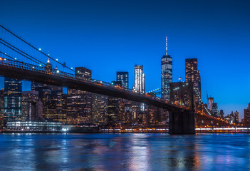 Fototapeta na wymiar New York City Panoramic landscape view of Manhattan with famous Brooklyn Bridge at dusk .