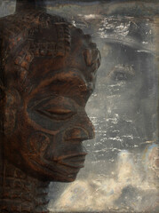 Fototapeta na wymiar Head of African wooden sculpture on grunge background.