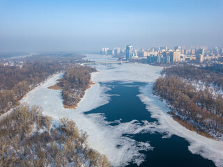 Melting Dnieper River in spring Kiev. Ice crack on the river. Aerial drone view. Spring sunny morning.