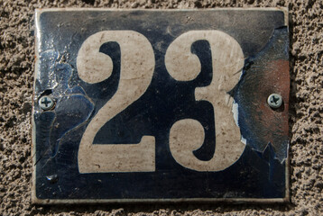 Weathered grunge square metal enamelled plate of number of street address with number 23