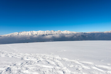 Mountain range of Monte Baldo and Adamello in winter with snow, view from the Altopiano della Lessinia (Lessinia Plateau), Verona Province. Veneto and Trentino Alto Adige, Italy, Europe.