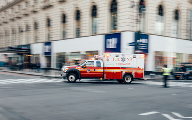 New York City, USA - March 18, 2017: FDNY Ambulance flashing lights siren blasting speed through...