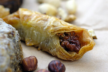 Honey baklava with walnuts. Turkish sweets based on honey and puff pastry. Delicious Turkish baklava in the shape of an envelope.