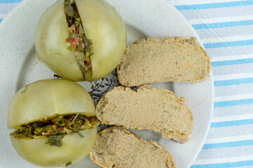 Green tomatoes with bread and pate top view. Bread spread with pate and stuffed with pickled...