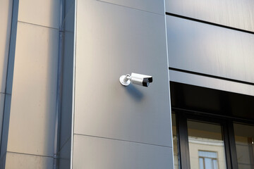 White Security Camera, CCTV on location. Video surveillance system on the office building.