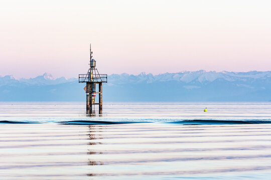 Lake Constance with European Alps and lighthouse in winter