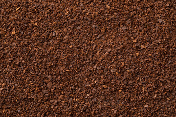 Coarse ground roasted coffee full frame close up as background