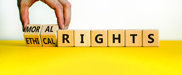 Ethical or moral rights symbol. Businessman turns wooden cubes and changes words ethical rights to...