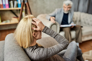 Upset young caucasian woman during appointment with psychotherapist