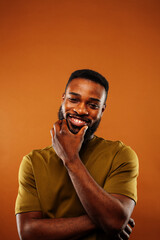 young pretty african american man posing cheerful on brown background, lifestyle people concept