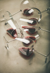 Red wine in glasses over grey concrete background, selective focus. Bojole nouveau, wine bar,...