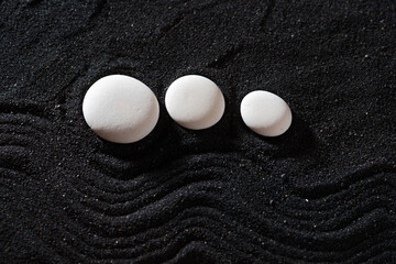 rock garden, white pebbles on black sand, wavy patterns.