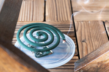 Closeup on traditional mosquito repellent coil emit smoke to repel mosquito outdoor