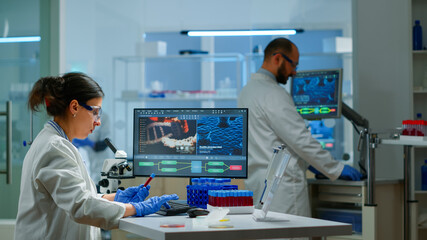 Team of microbiology scientists discussing about virus development in modern equpped laboratory...