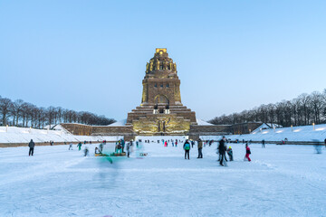 Leipzig, Germany - 02.13.2021: People playing ice hockey and skating on ice in front of the...