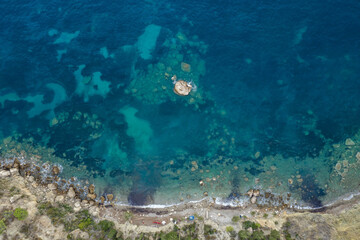 Naklejka na ściany i meble Aerial overhead drone shot of Adriatic coastline in Komiza town on Vis Island in Croatia summer