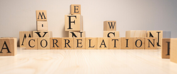 The word correlation is from wooden cubes. Background from wooden letters.