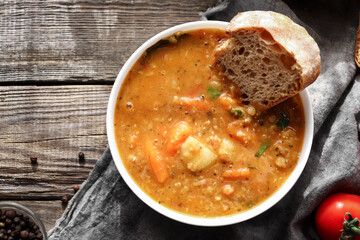 Soup with vegetables and red lentils. Vegan soup with beans and tomatoes.