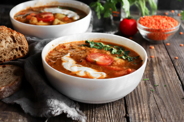 Soup with vegetables and red lentils. Vegan soup with beans and tomatoes.