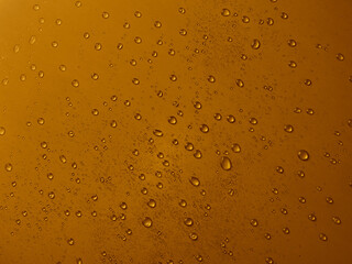 Random water drops on the gold PVC surface
