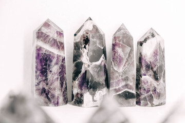 Amethyst polished crystal pyramids on a white background. Copy, empty space for text