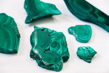 Malachite polished stones on a white background. Copy, empty space for text