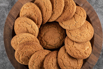 Close up photo o f wooden tray full with fresh homemade cookies