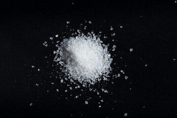 white sea salt on black background