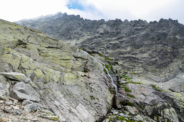 Scenic view of sharp rocky mountains covered with clouds in High Tatras, Slovakia 