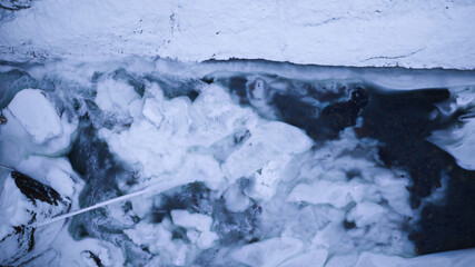 blue white snowy river in winter aerial