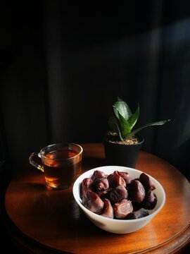 Dates and tea on the wooden table for breakfast
