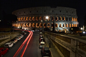 Fototapeta na wymiar colosseum at night with red car lights 