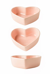 Heart shaped pink plate isolated on white with different angle of view