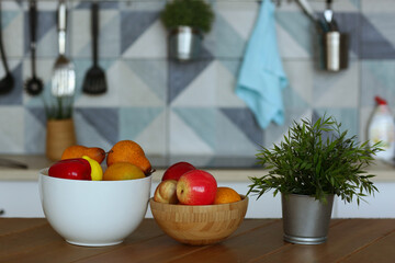 fruit in bowl still life on the table closeup photo on blue kitchen background